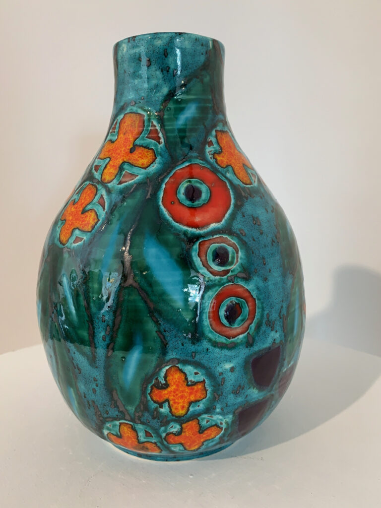 hand decorated green, red and orange vase